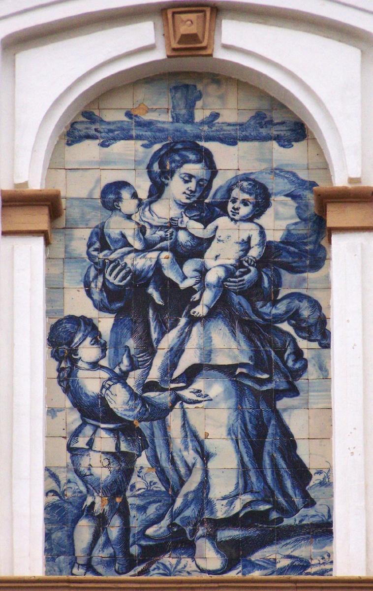 00037. Retablo cerámico. Alegoría de la Caridad. Fachada de la Iglesia de San Jorge. Sevilla.